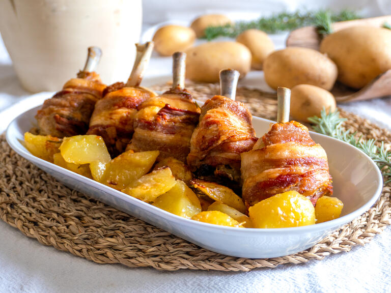 The chicken, wrapped in crispy slices of bacon, re...